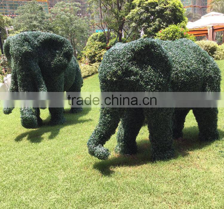 Green grass elephant statue