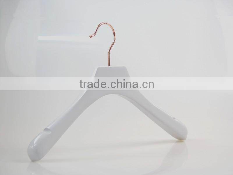 white wooden hanger and pants hanger for luxury garment