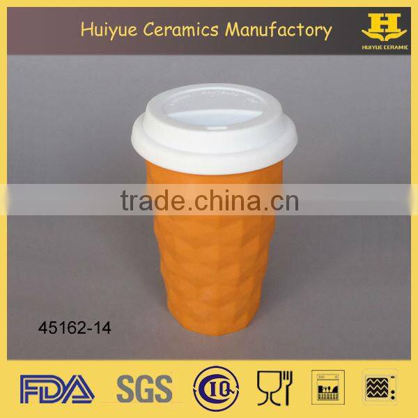 Insulated double wall embossed ceramic travel mug with silicone lid