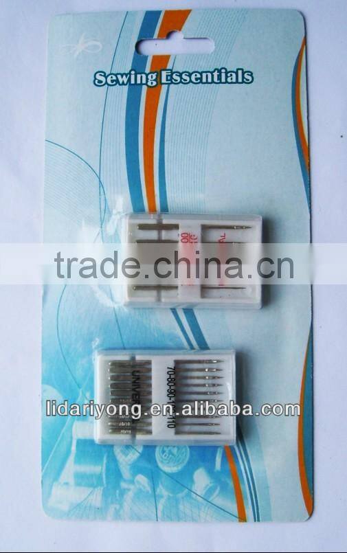 sewing machine needles and metal bobbins in paper card