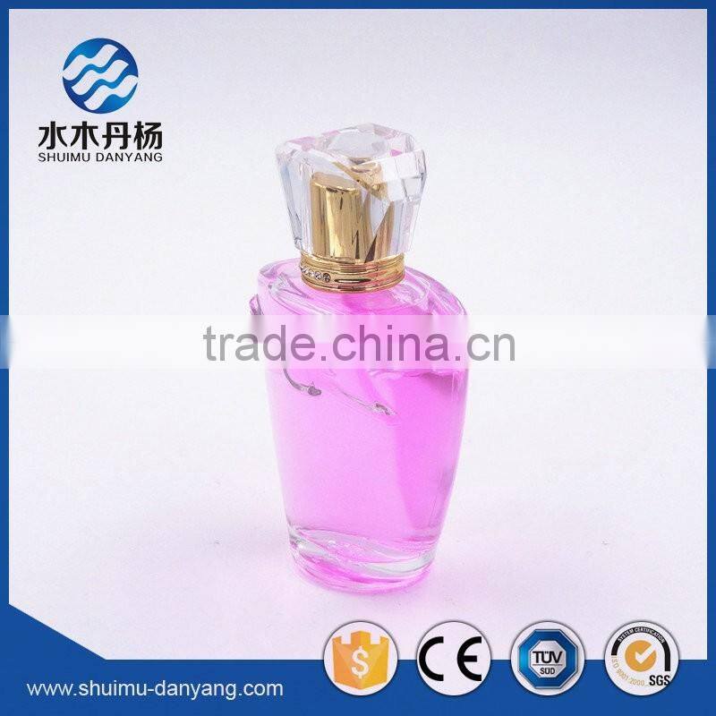 Hot sale 100ml clear glass perfume bottle with fancy cap
