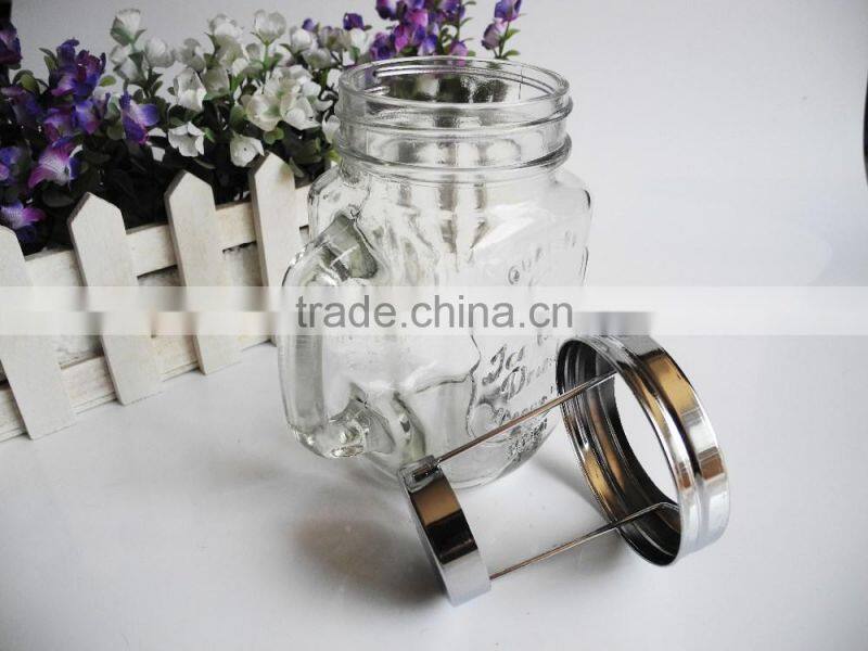 Decorated candle in clear glass jar