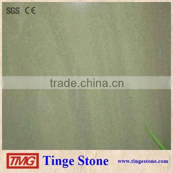 Cut to size green sandstone tiles and brick for paving