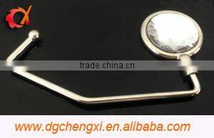 China hot sale round shape bag hanger with CX logo and metal hook