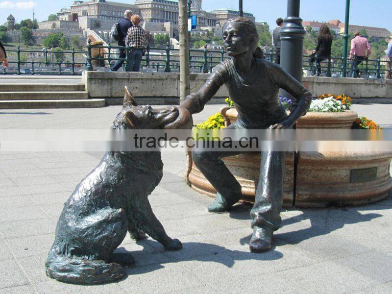 bronze girl with dog playing sculpture