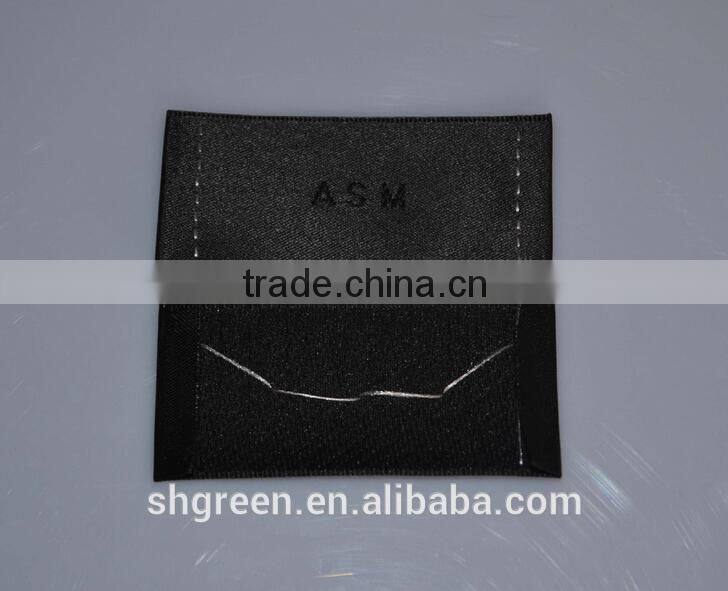 straight cut black background black logo woven label