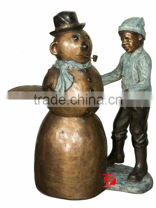 Bronze boy making snowman statues for garden