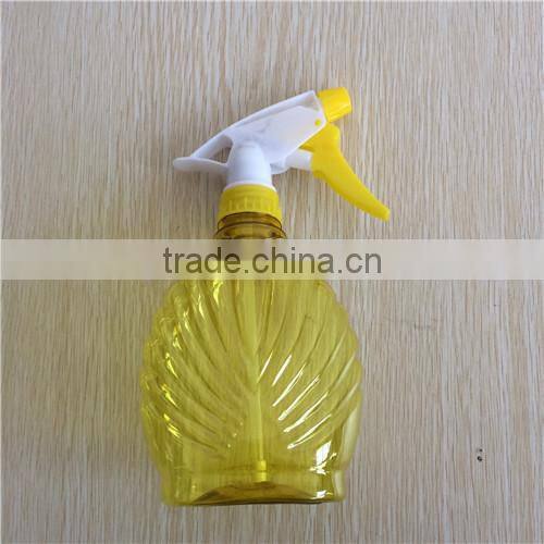 yellow transparent plastic garden spray bottle with trigger