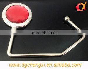 China hot sale round shape bag hanger with CX logo and metal hook