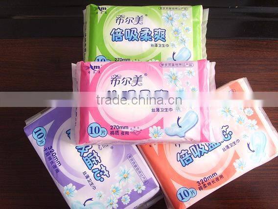 Disposable high absorbency dry surface sanitary napkin