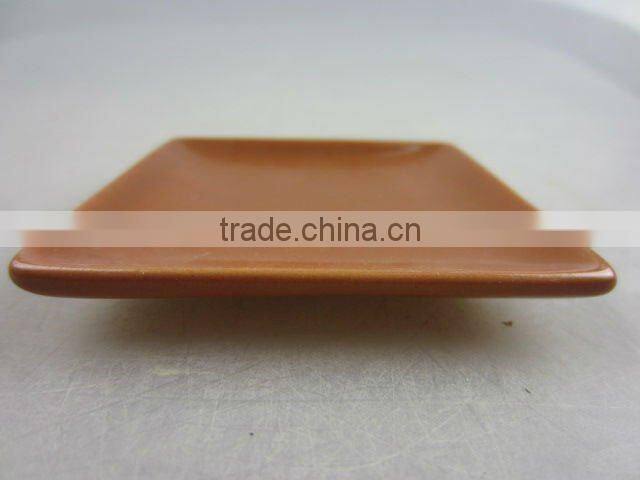 Stock glazed porcelain square sauce dish