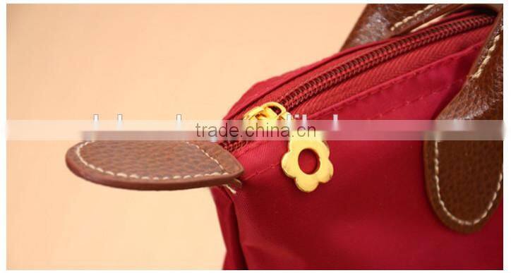 Foldable nylon shopping bag with zipper and button closure