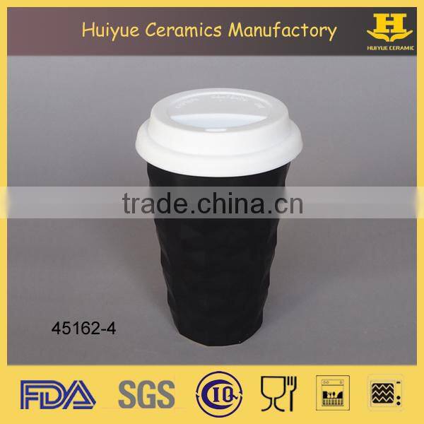 Insulated double wall embossed ceramic travel mug with silicone lid