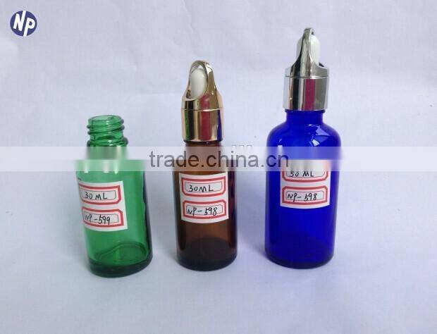 green essential oil glass bottle with dropper