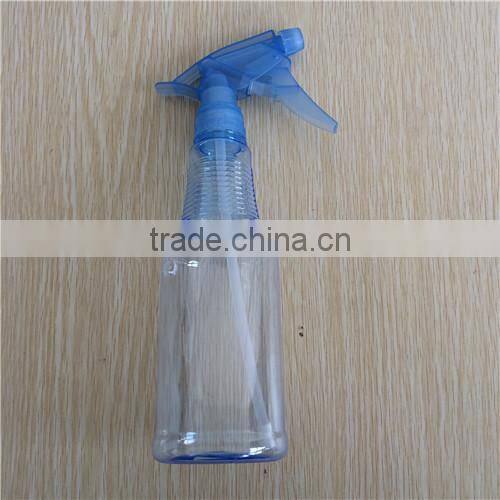 blue transparent plastic garden spray bottle with trigger