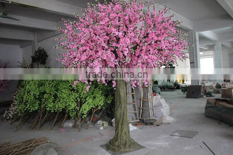 Pink artificial cherry blossom trees with rotating base
