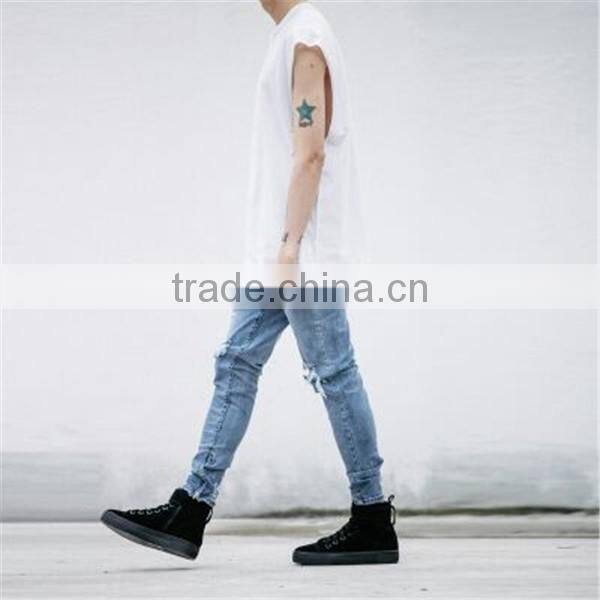 Slightly faded blue jeans with zip down whiskering ripped pants