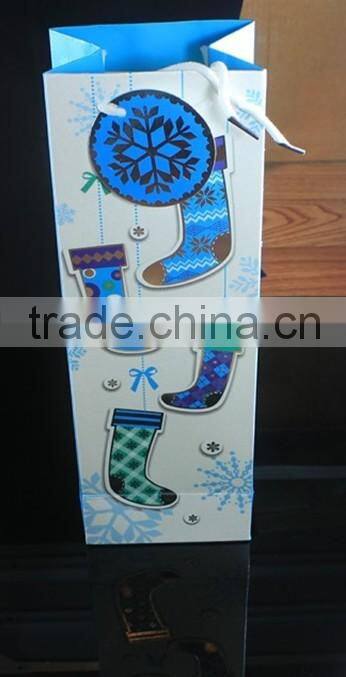 Handmade paper bottle bag with socks and snow