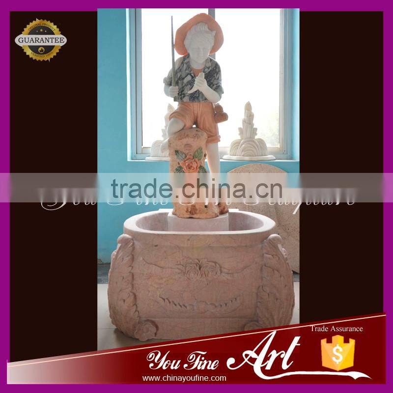hand carved nature stone fountain with little boy
