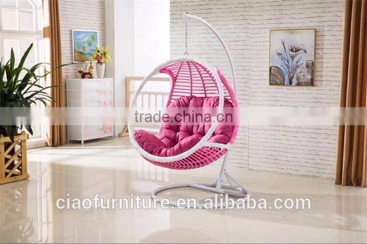 Round Wicker Hanging Chair In Room With Ottoman