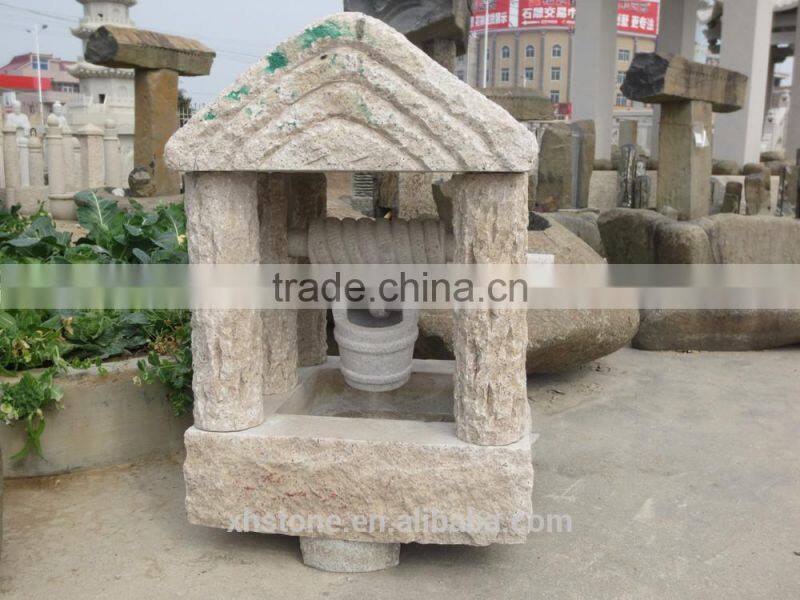 Hand carved garden stone water fountain in Chinese well style .