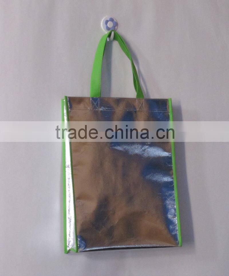Silver colour laser bag with gree handle