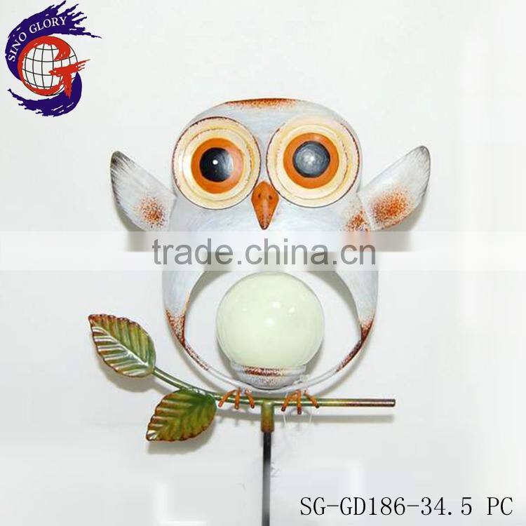 decorating garden edging with metal glow in dark bird stake