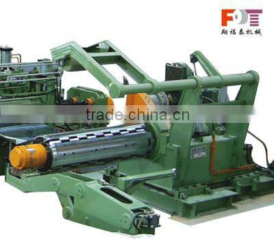 rewinder with hold down arms device