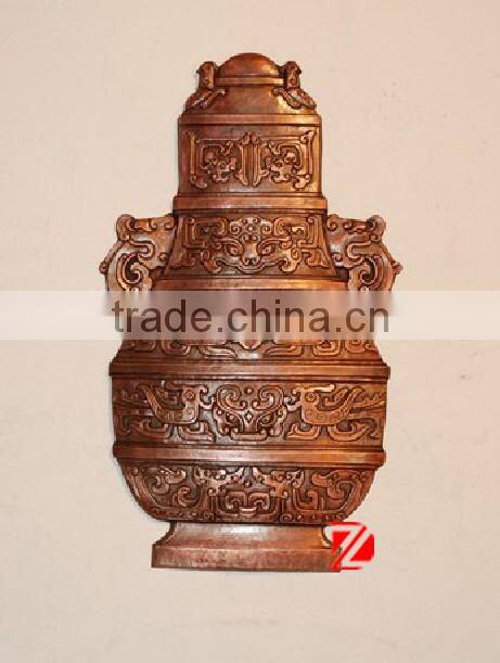 bronze modern relief sculpture with vase