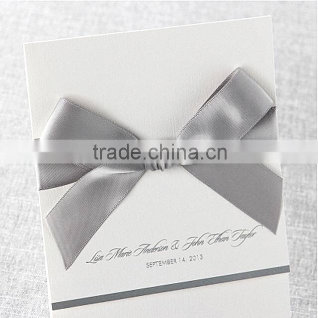 Elegant & romantic white pocket fold wedding invitation with silver bow & silver border