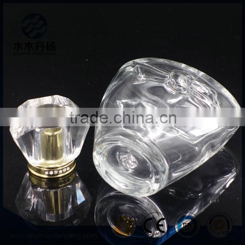 Hot sale 100ml clear glass perfume bottle with fancy cap