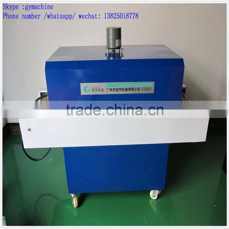 Automatic over wrapping heat shrinking machine