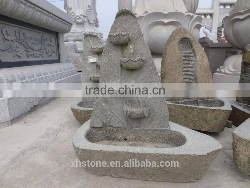 Hand carved garden stone water fountain in Chinese well style .