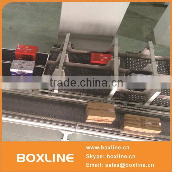 Flexible mesh conveyor for heavy cartons