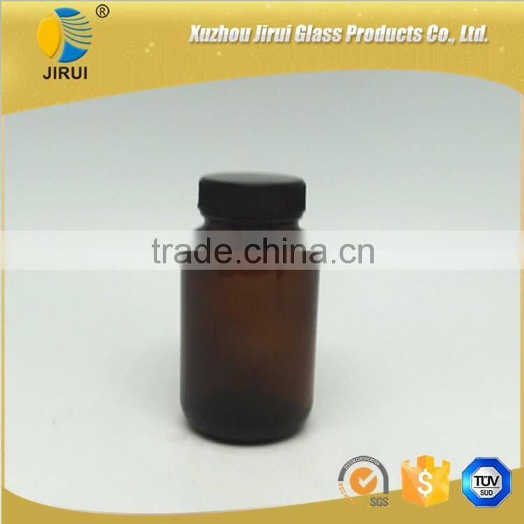 Amber vitamin pill glass bottle with lined black closure