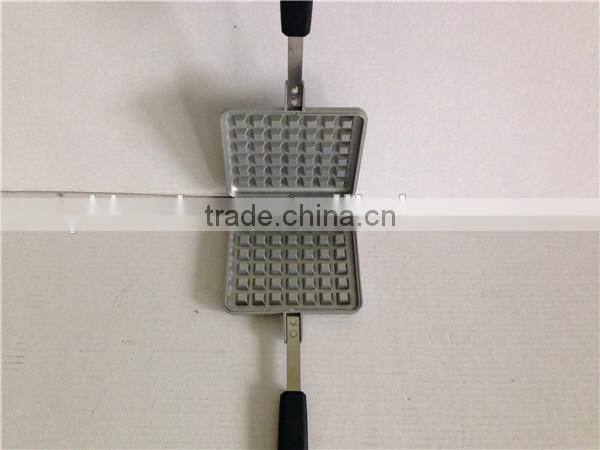 aluminum die cast non stick waffle iron maker on camp fire