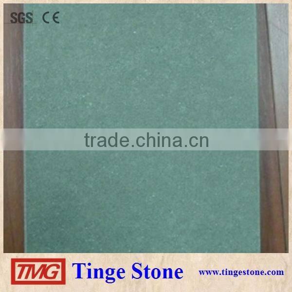 Cut to size green sandstone tiles and brick for paving
