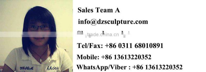 Garden playing boy and girl sculptures with teeterboard