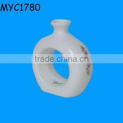 White ceramic napkin ring vase