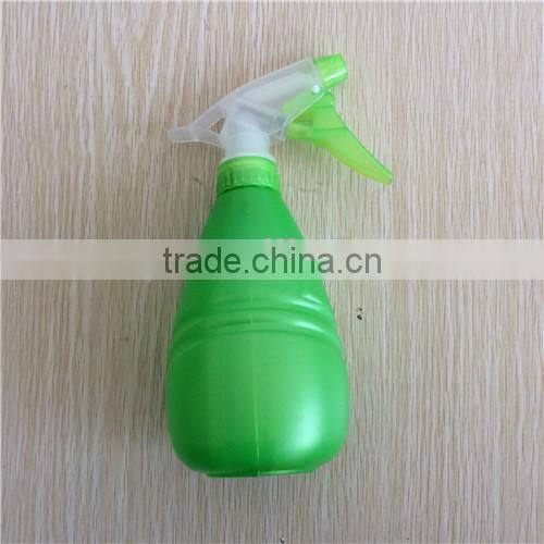 green plastic garden spray bottle with trigger