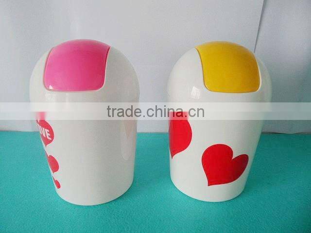 Round swing-top plastic trash can