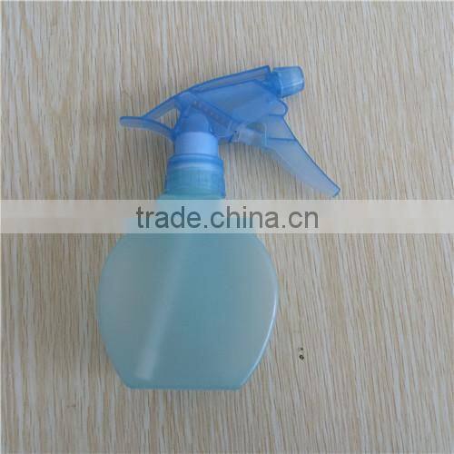 blue transparent plastic garden spray bottle with trigger