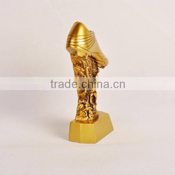 Gold football shoe with figure trophy
