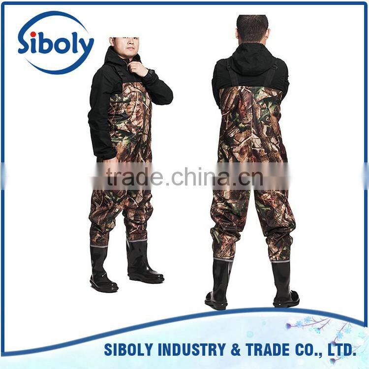 cheap pvc chest high fishing waders being used as waterproof workwear