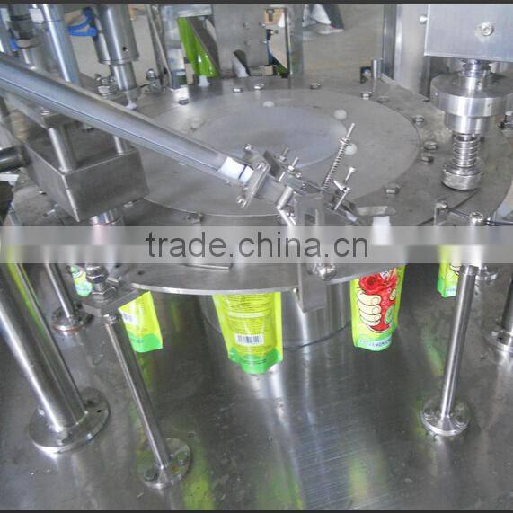Stand bag juice filling and sealing machine with date printer and inlet and outlet conveyors