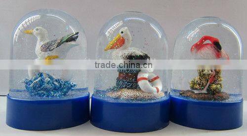 Plastic sea snow globe with boat figurine inner