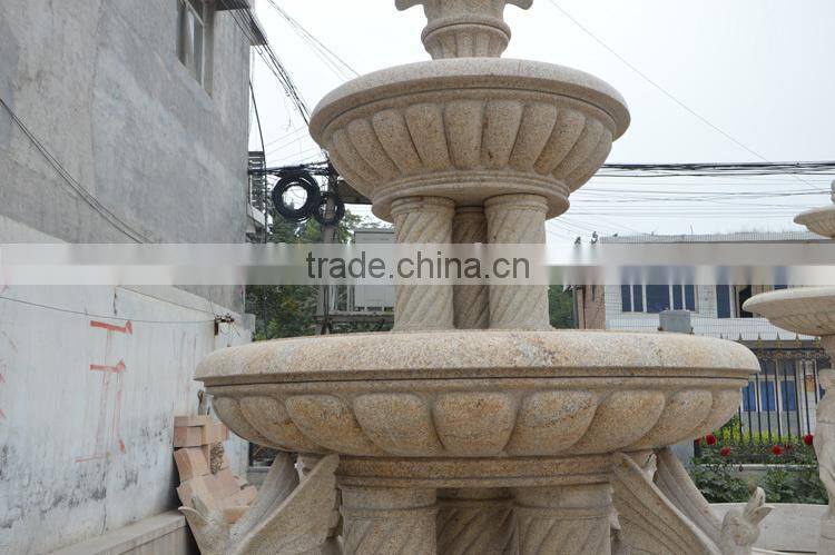 Yellow granite column water fountain with swan