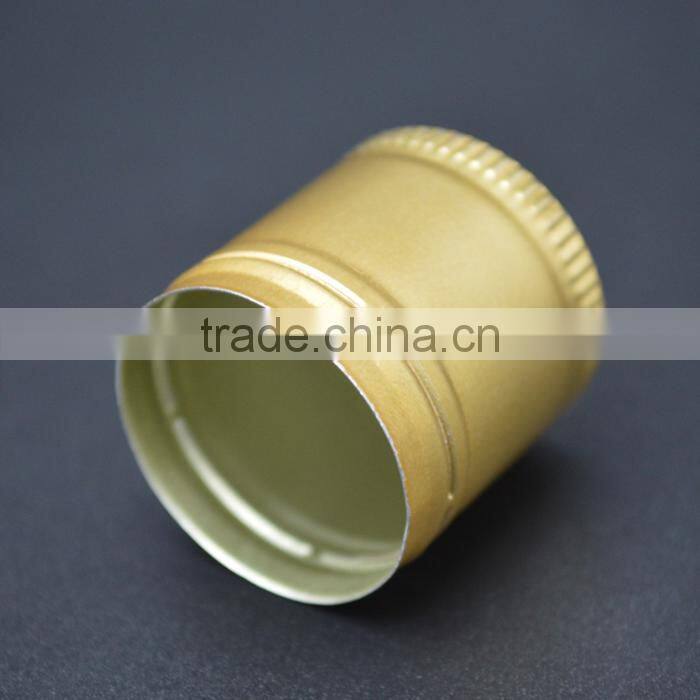 Golden aluminium caps for wine glass bottles