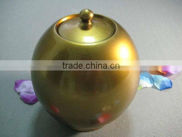 Golden ceramic urns for ashes