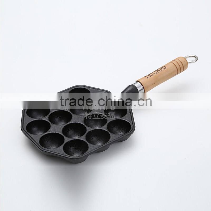 Mini cast iron takoyaki grill with wooden handle